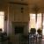 Interior of screened porch, looking toward the fireplace